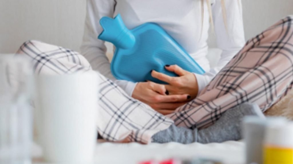 Person holding a hot water bottle